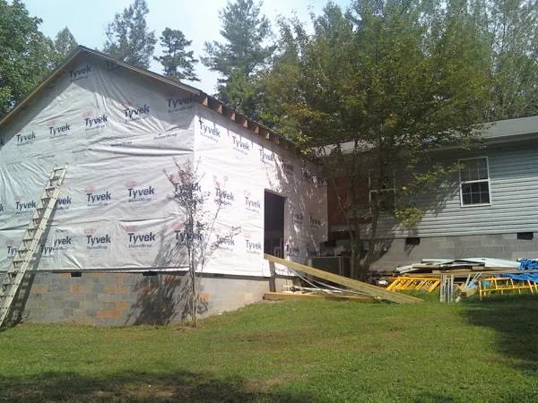 Tyvek wrapped gable on a new room addition beside an existing home in Forney